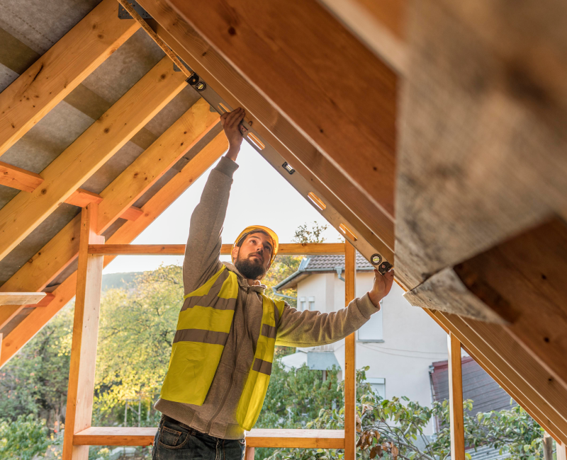 Contractor working on roof framing during a home addition construction project on a Mississauga house